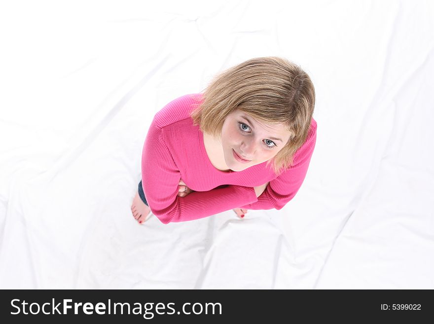 Pretty teenage girl standing on a white background.  Shot from above. Pretty teenage girl standing on a white background.  Shot from above