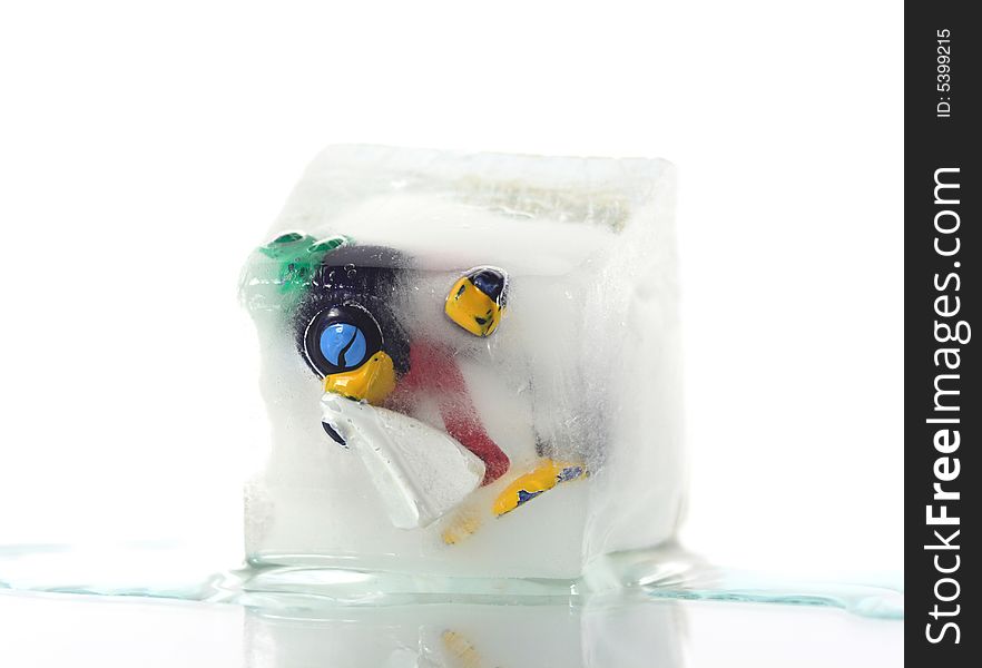 Frozen penguin with a cold in a block of ice