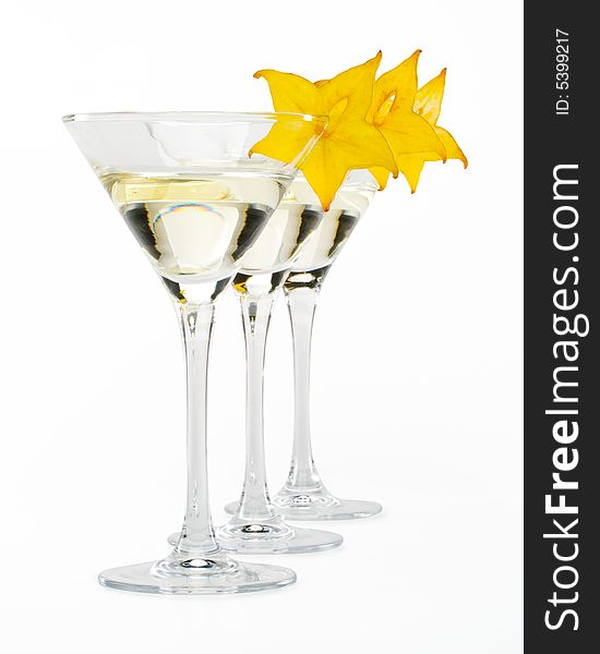 Glass of martini and slice of carambola on a white background. Glass of martini and slice of carambola on a white background