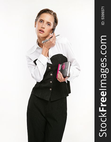 Attractive Fine business-lady holds phone and a pen