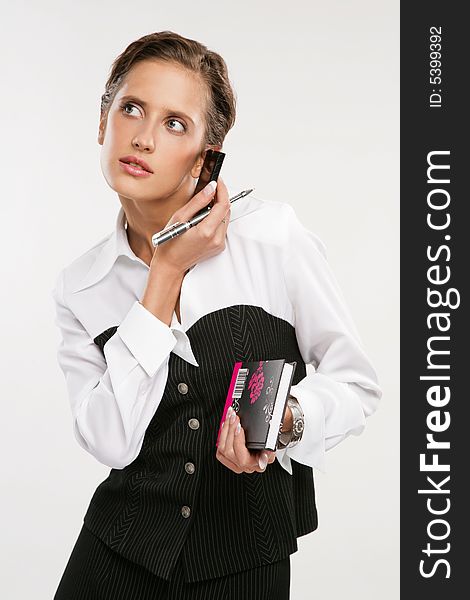 Attractive Fine business-lady holds phone and a pen