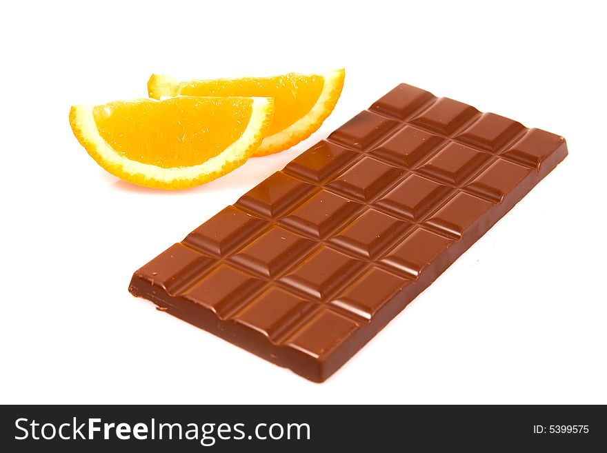 Chocolate bar with orange slices against white background. Chocolate bar with orange slices against white background