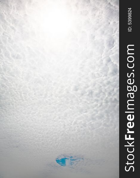 Cloudscape: small clouds and a piece of sky, vertical orientation. Cloudscape: small clouds and a piece of sky, vertical orientation