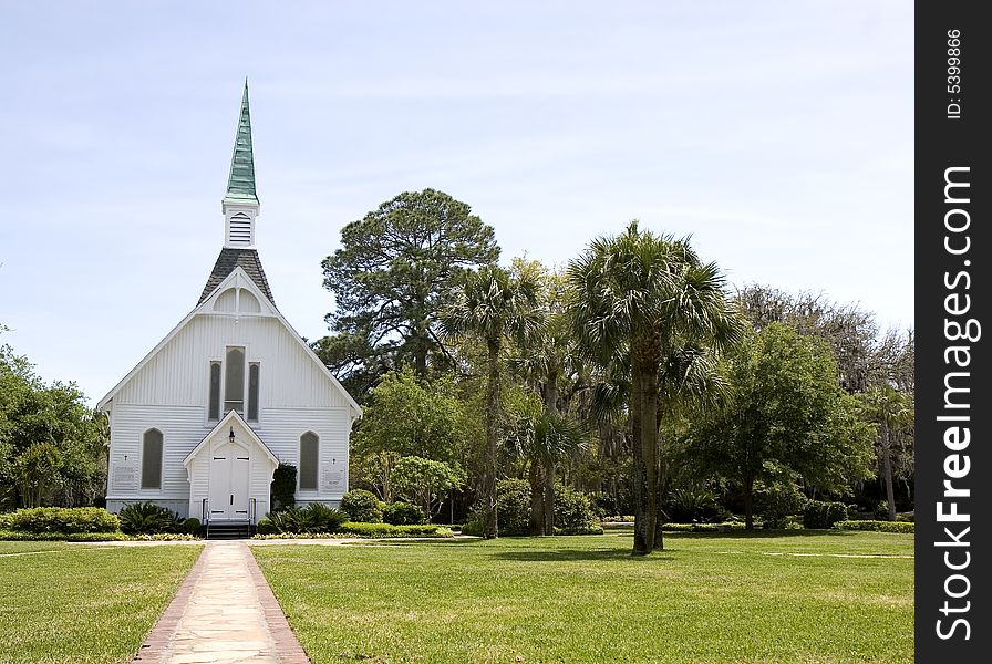 A small church along a path through the grass. A small church along a path through the grass