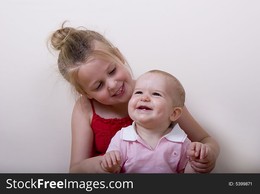 Girl and Baby Smiling