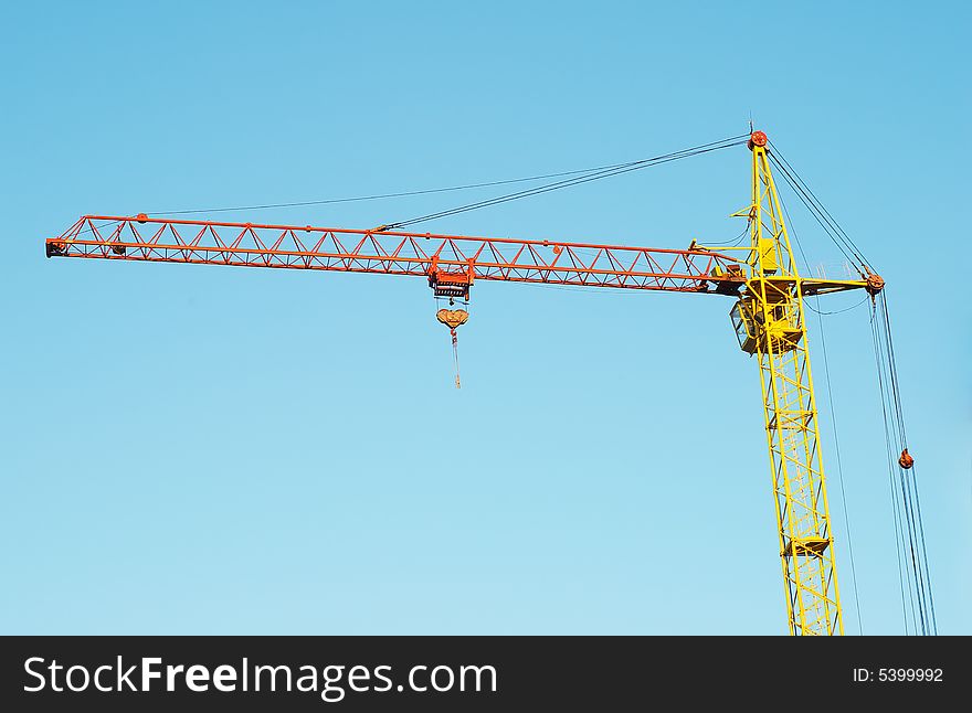 Lifting crane in the blue sky. Lifting crane in the blue sky