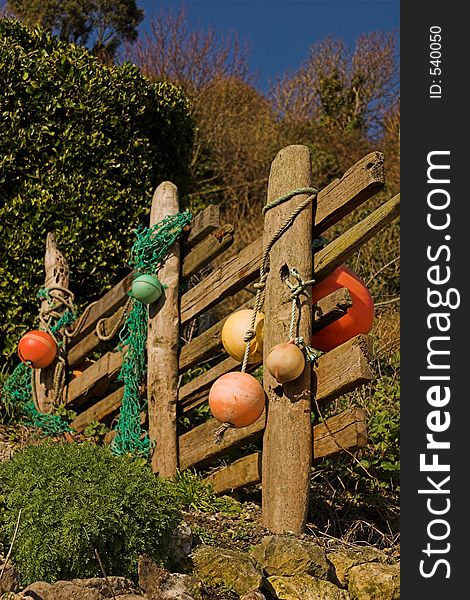 Driftwood fence with colored floats. Driftwood fence with colored floats