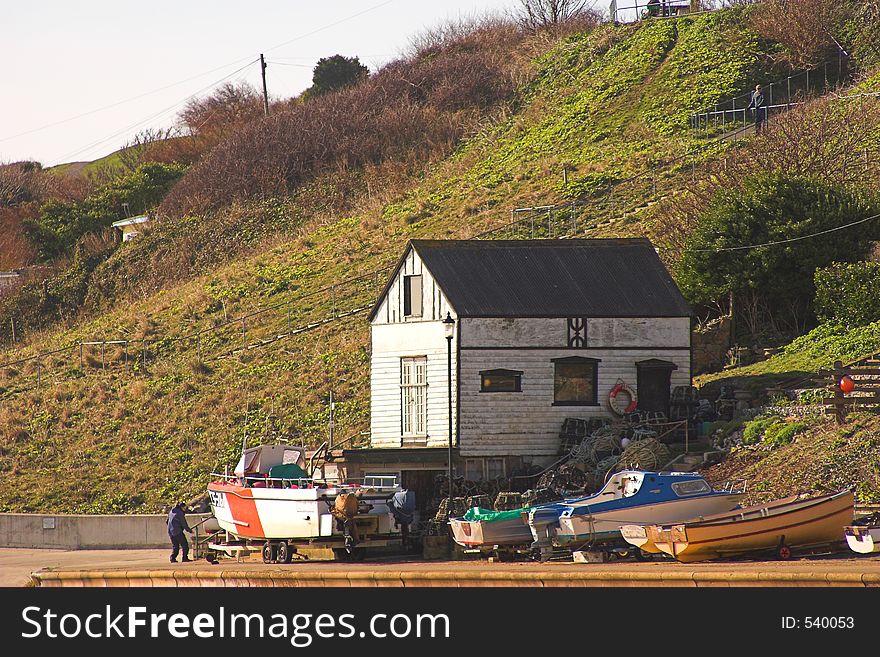 Old boathouse & boats with hillside