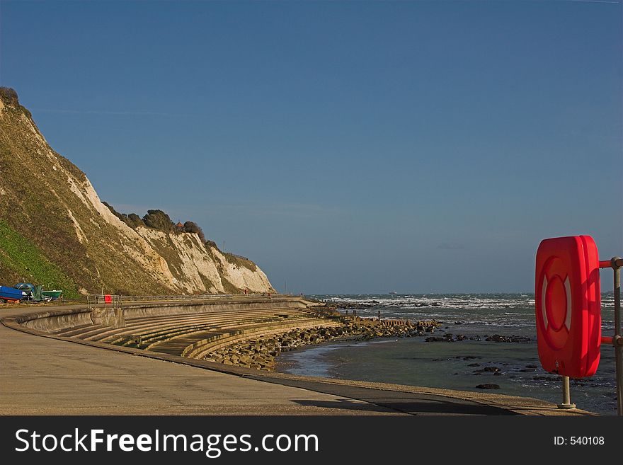 Seaside path with red lifebuoy. Seaside path with red lifebuoy