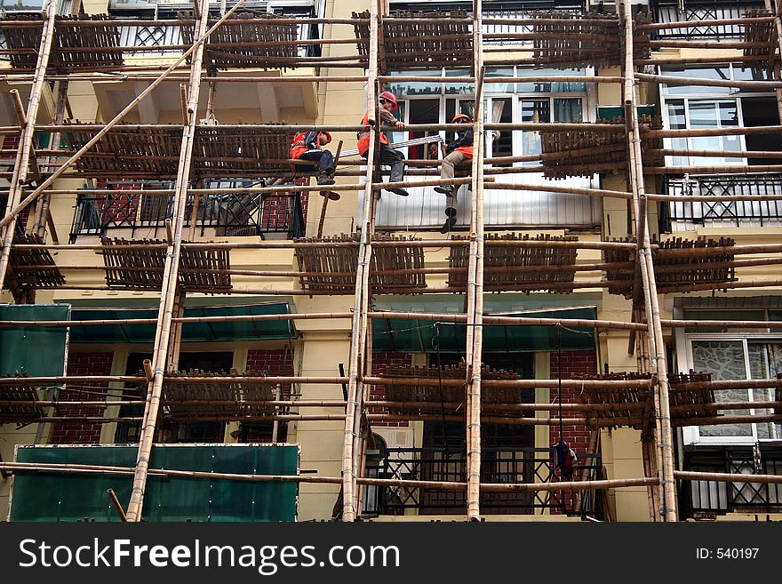 Workers taking a break in mid-air on a scaffold structure