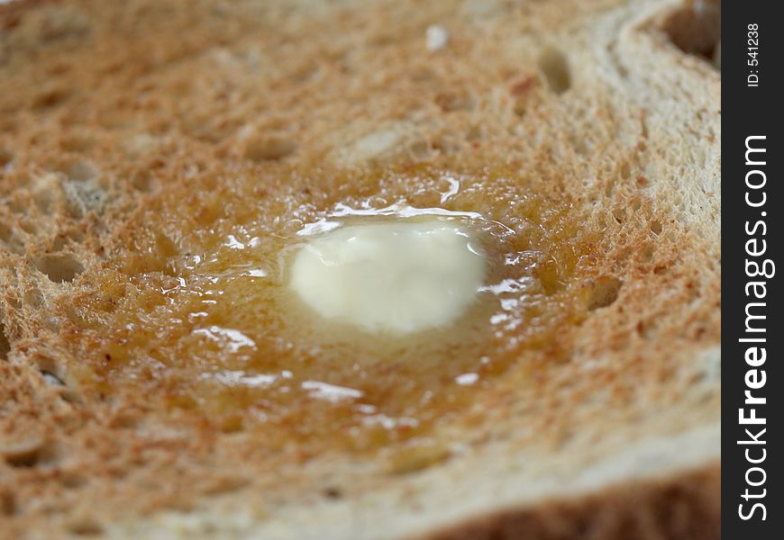 Slice of wheat toast with melting butter. Slice of wheat toast with melting butter