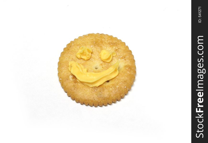 Close up of a snack cracker with a smiley face, isolated on white. Close up of a snack cracker with a smiley face, isolated on white