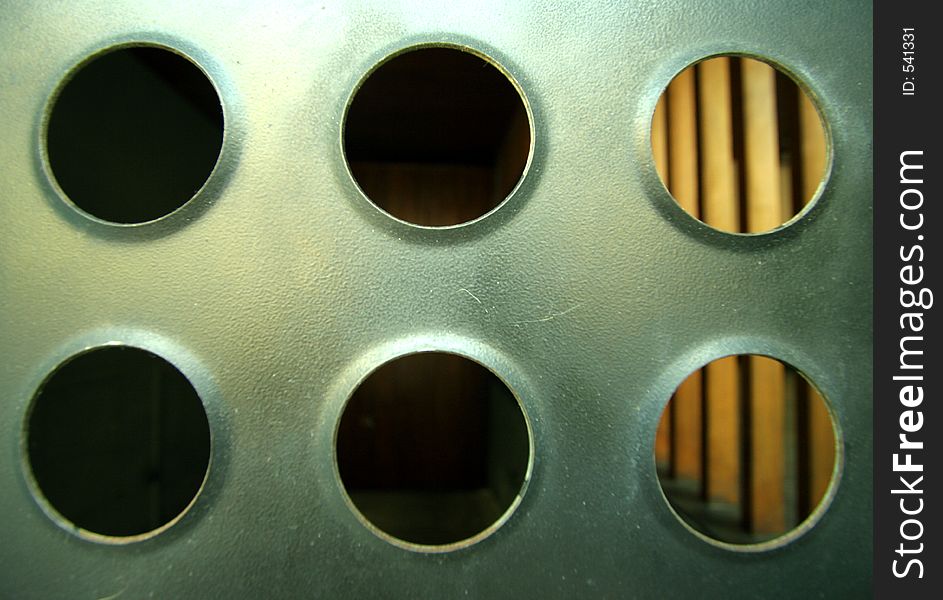 Close-up of sheet of metal with holes in urban building. Close-up of sheet of metal with holes in urban building