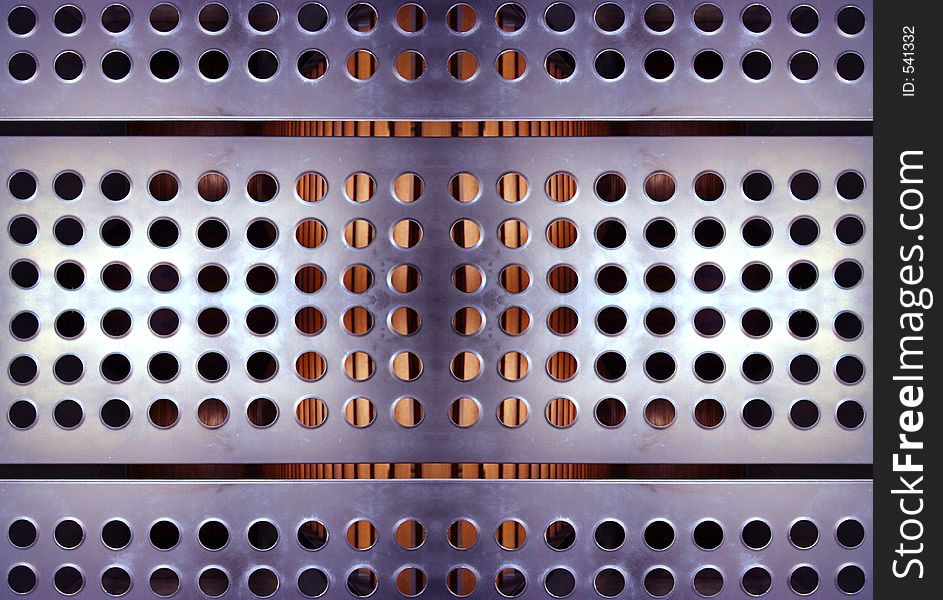 Close-up of sheet of metal with holes in urban building. Close-up of sheet of metal with holes in urban building