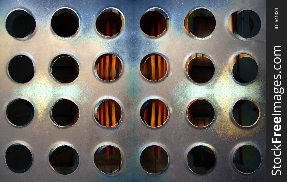 Close-up of sheet of metal with holes in urban building. Close-up of sheet of metal with holes in urban building