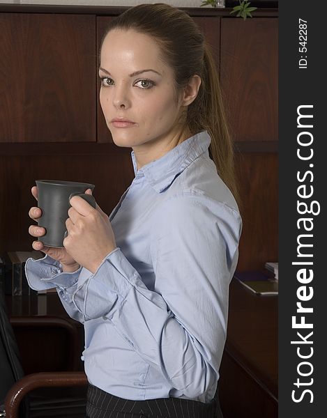 Young businesswoman holding a cup of coffee. Young businesswoman holding a cup of coffee.