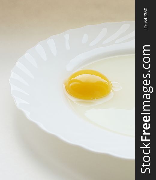 Still life with egg on white dish and white background. Still life with egg on white dish and white background