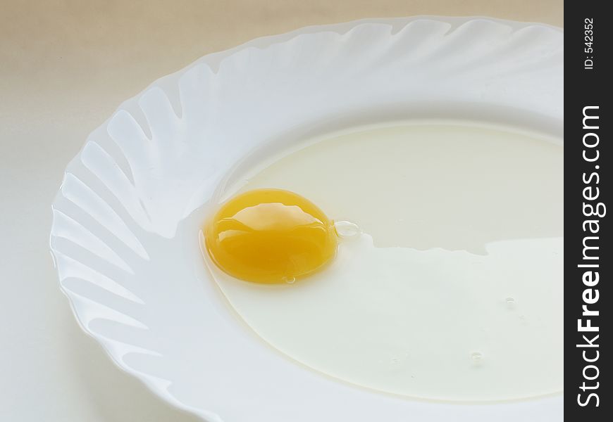 Still life with egg on white dish and white background. Still life with egg on white dish and white background
