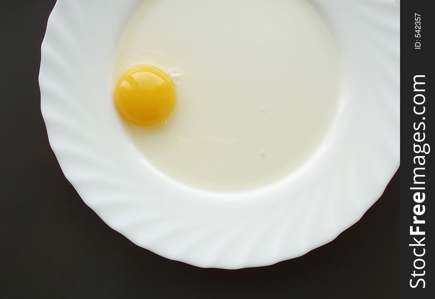 Still life with egg on white dish and black background. Still life with egg on white dish and black background