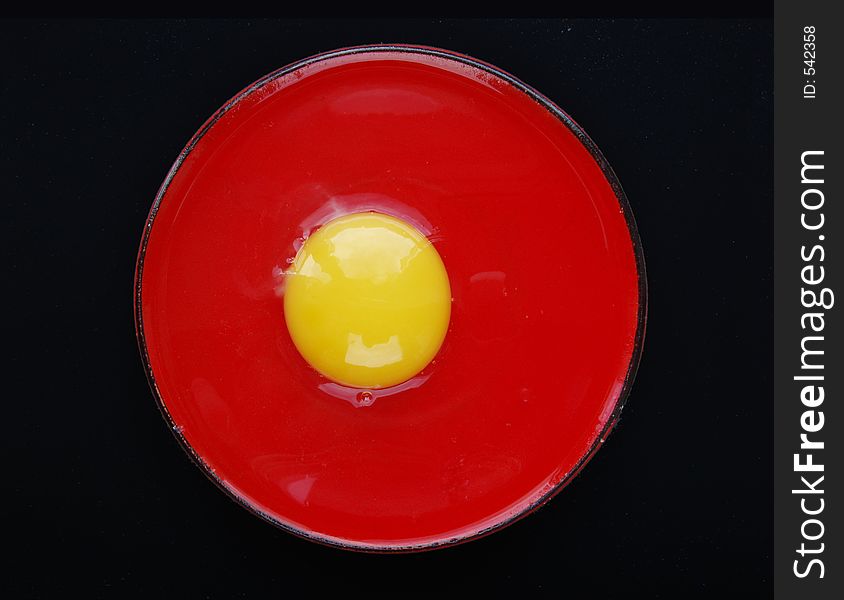Still life with egg on red and black colours. Still life with egg on red and black colours