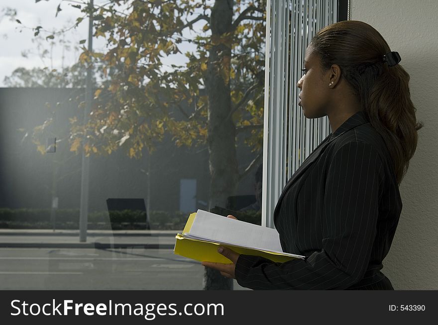African-american office woman sitting near the window. African-american office woman sitting near the window