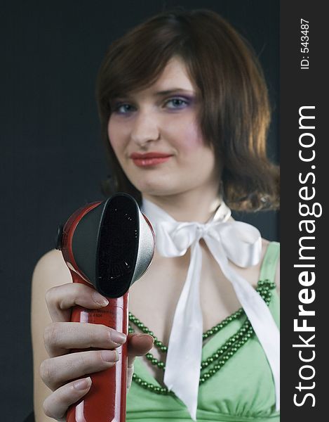 Young woman pointing the hairdryer at you. Young woman pointing the hairdryer at you
