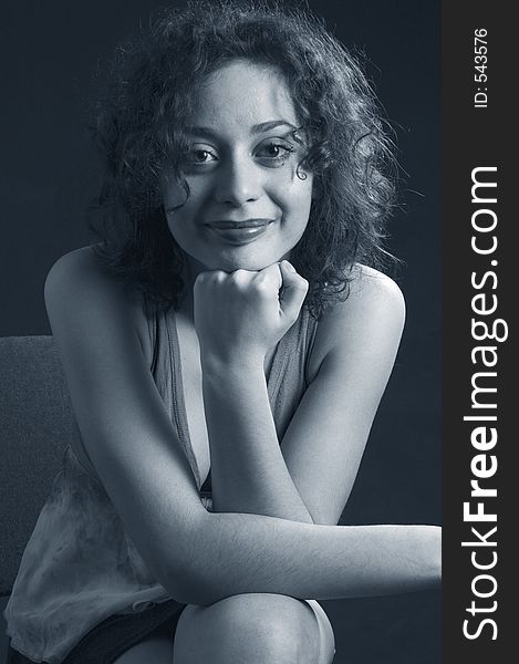 Young woman with curly hair, smiling. Young woman with curly hair, smiling