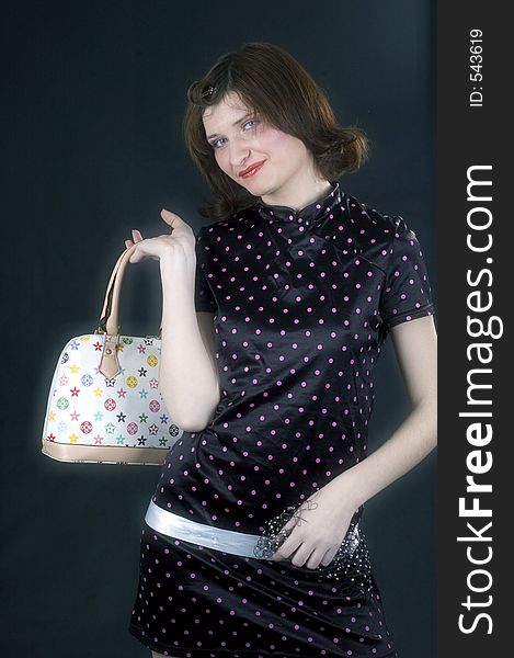 Young woman showing her brand new stylish purse. Young woman showing her brand new stylish purse.