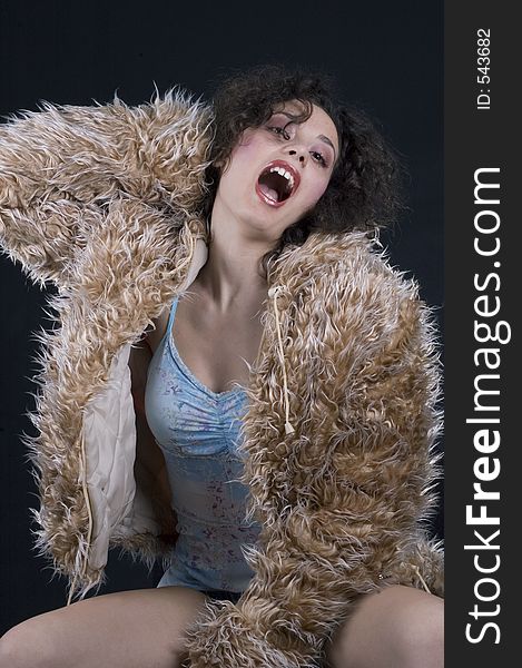 Young woman in fur coat going wild. Young woman in fur coat going wild