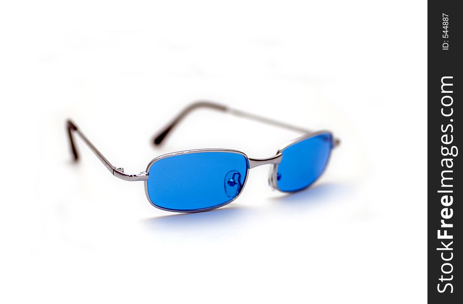 A pair of blue/silver sunglasses isolated against a white background. A pair of blue/silver sunglasses isolated against a white background.
