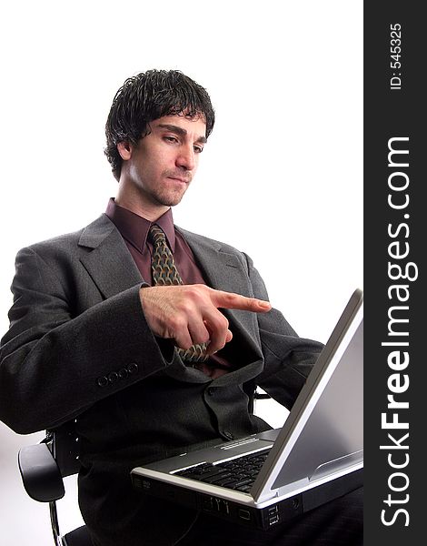 Businessman working on laptop pointing finger