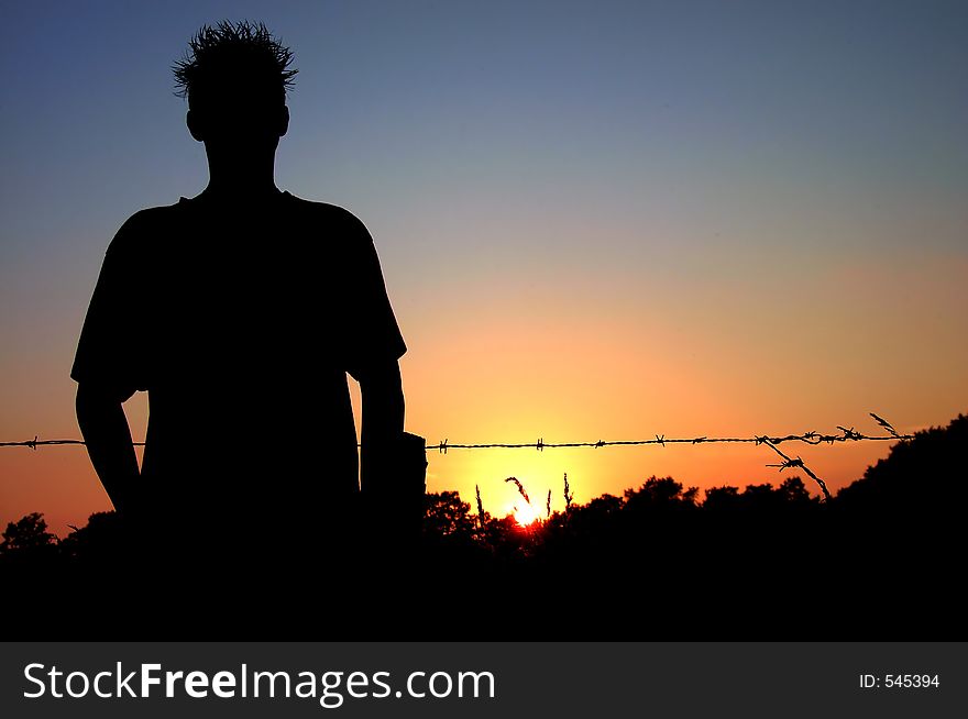 Barbwired Silhouette At Sunset