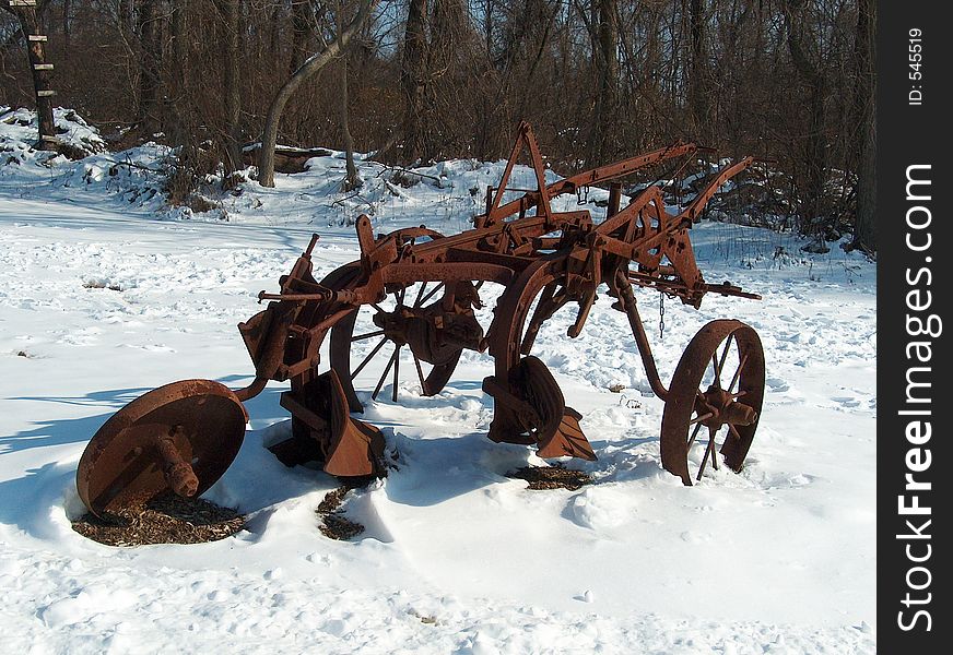 This weathered plow sits in retirement. the earlier years must have been busy.