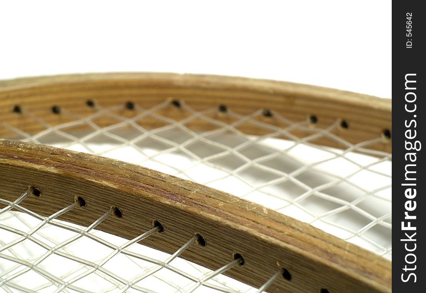 The bindings of the strings on wooden badminton rackets. Very old rackets. Shallow depth of field. Focus on the frame of the racket where the binding is. The bindings of the strings on wooden badminton rackets. Very old rackets. Shallow depth of field. Focus on the frame of the racket where the binding is.