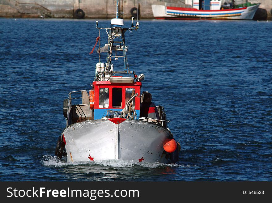 Boat returning from fishes in harbor