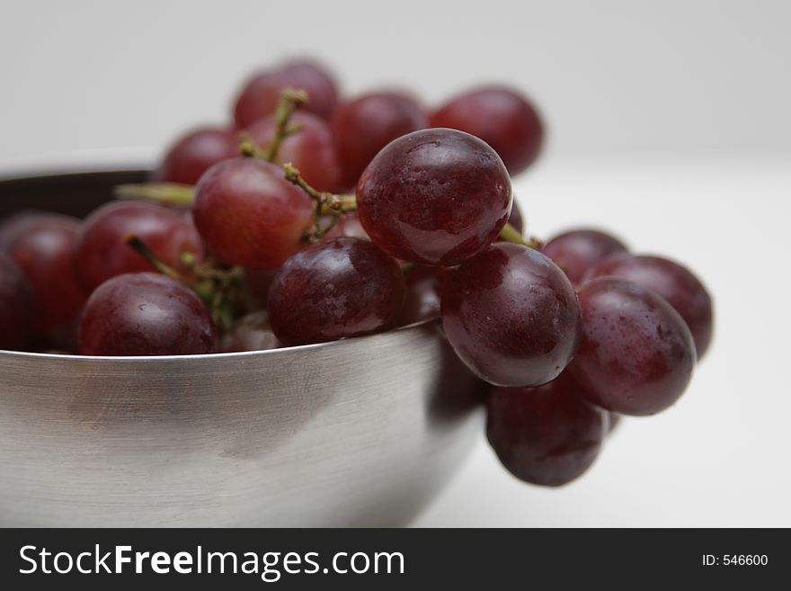 Red grapes in a silver bowl cropped shot. Red grapes in a silver bowl cropped shot