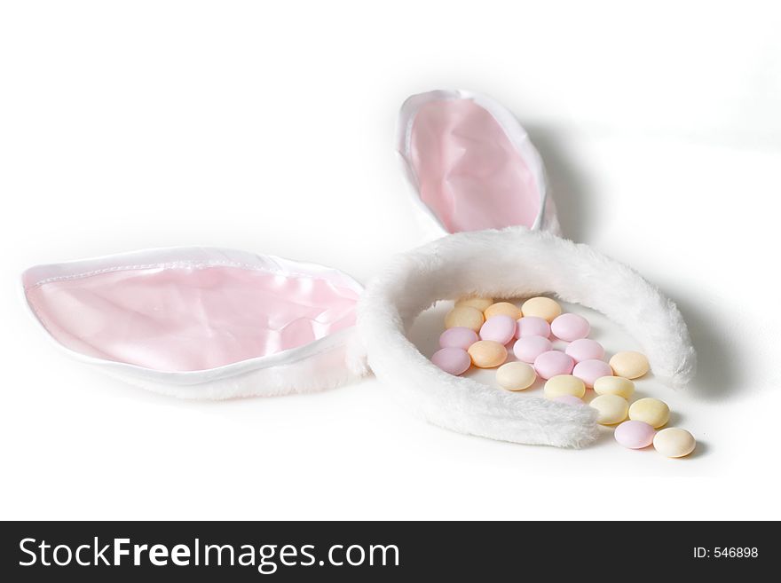Bunny ears and easter candy isolated on white