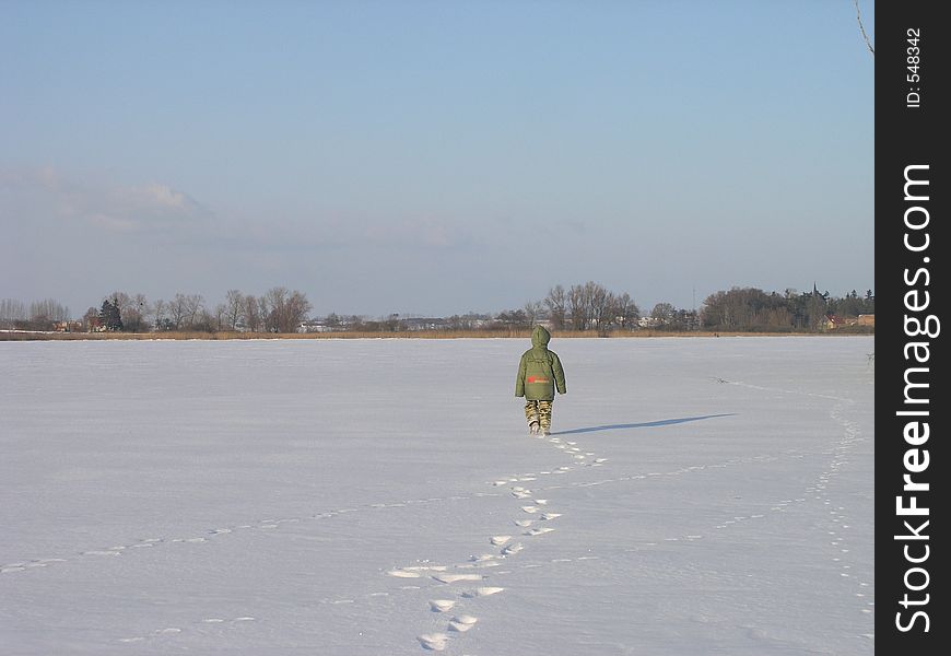 Kid walking on the frozen lake. Kid walking on the frozen lake