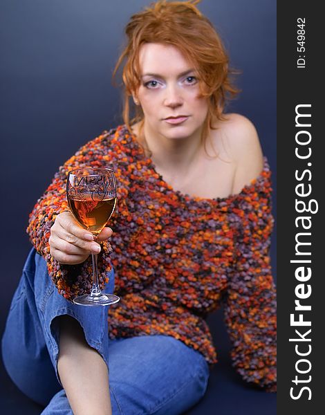 Beautiful red haired lady with glass of red wine in her hand. Beautiful red haired lady with glass of red wine in her hand