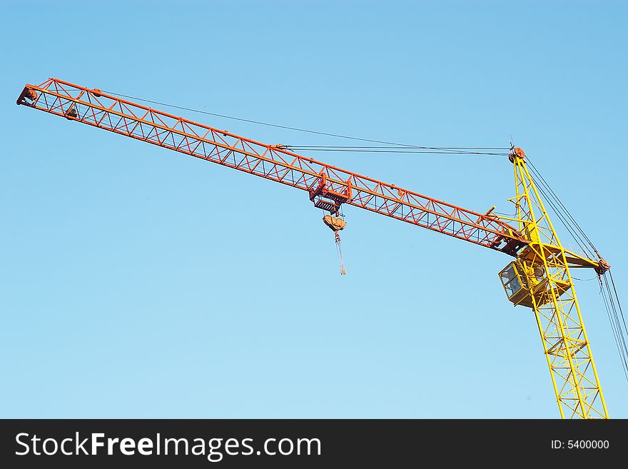 Lifting crane in blue sky. Lifting crane in blue sky