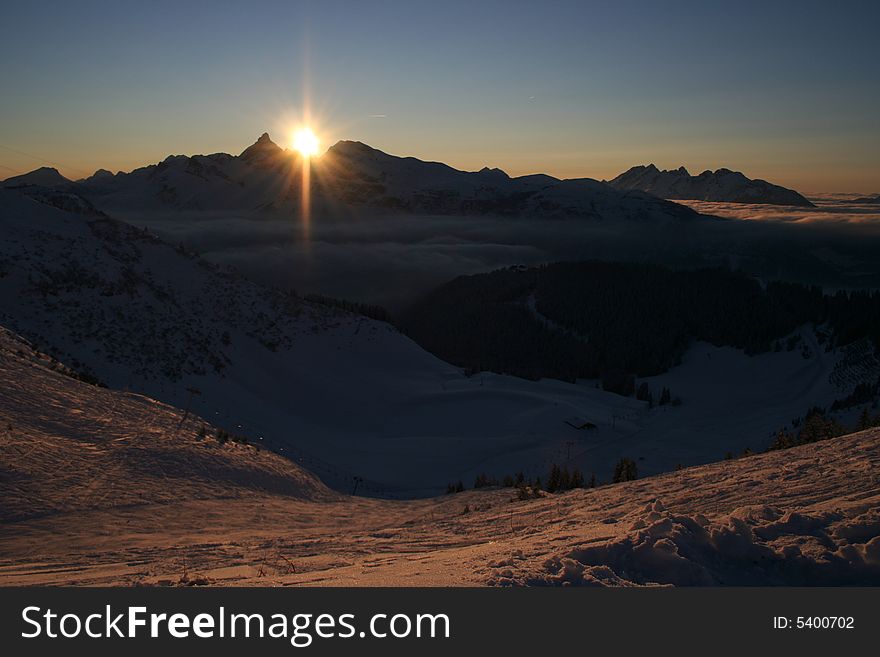Winter mountains with sunset skies. Winter mountains with sunset skies