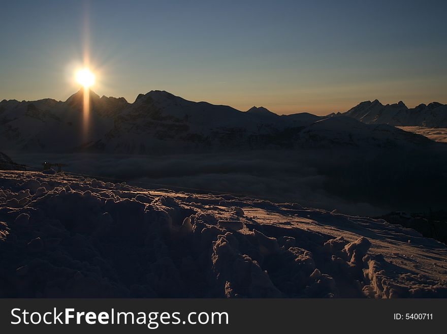 Winter mountains with sunset skies. Winter mountains with sunset skies