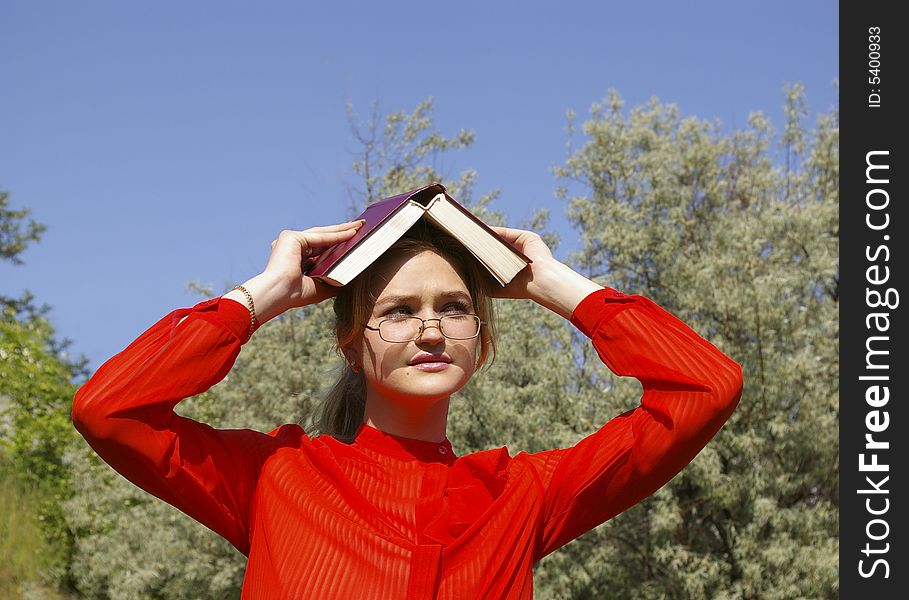 Smiling woman in red holding a book