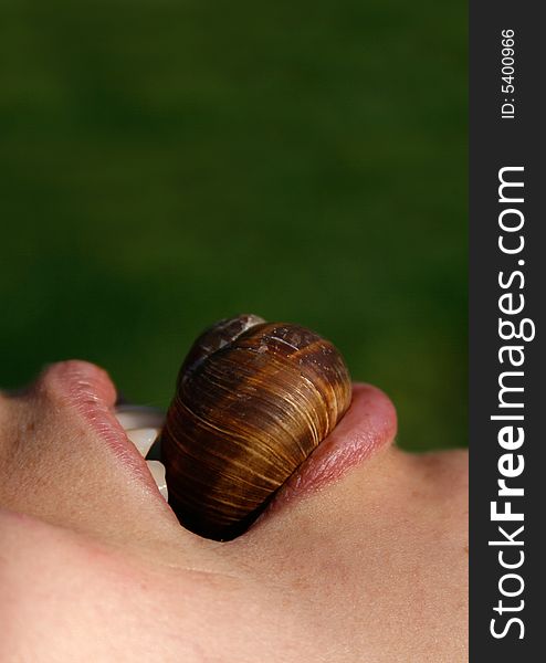 Girl eating a shell close-up