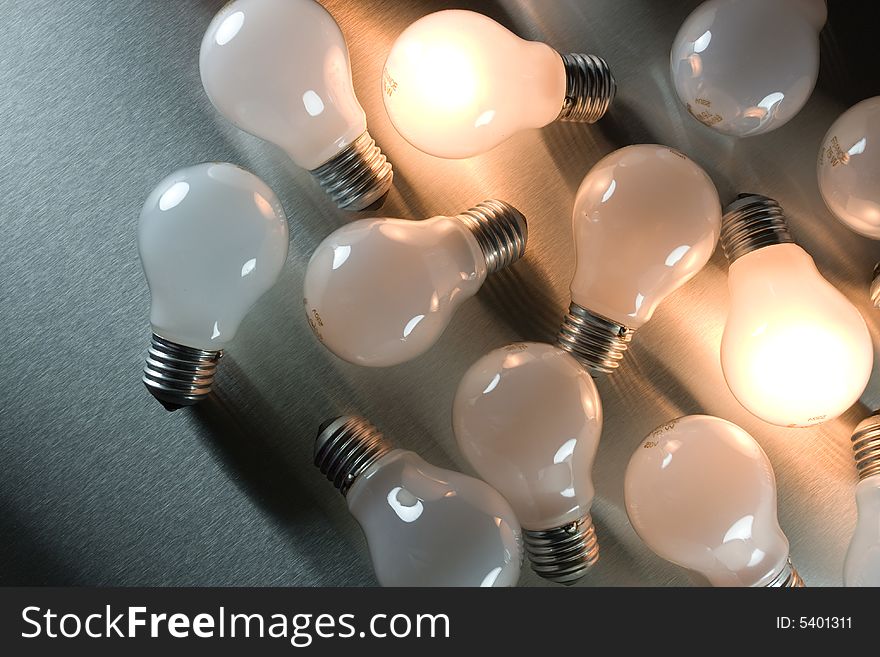 Series of lightbulbs on metal desk