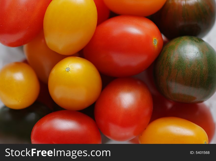 Small red, yellow and green tomatoes background. Small red, yellow and green tomatoes background