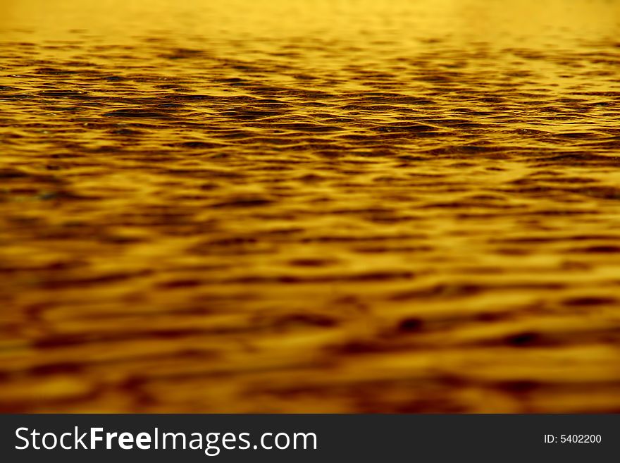 Background of golden waters, crispy little waves