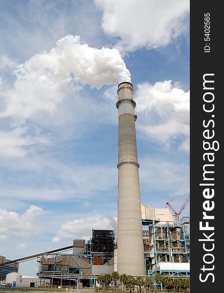 Looking up at a power plant smoke stack