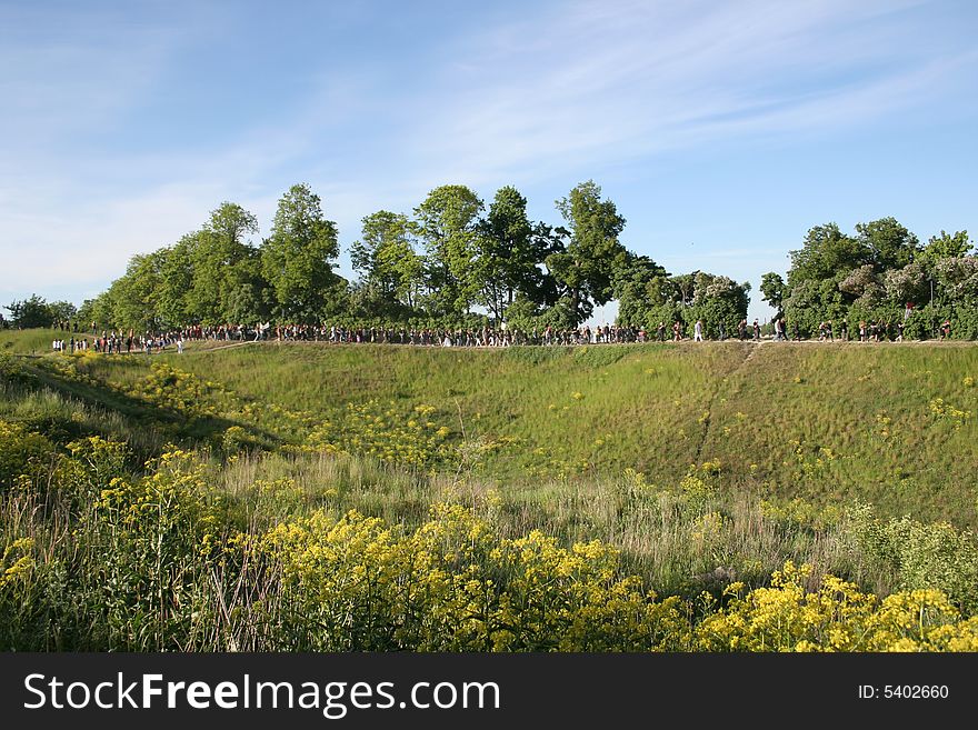 Blossoming hills in Estonia, procession of choristers on a singing holiday