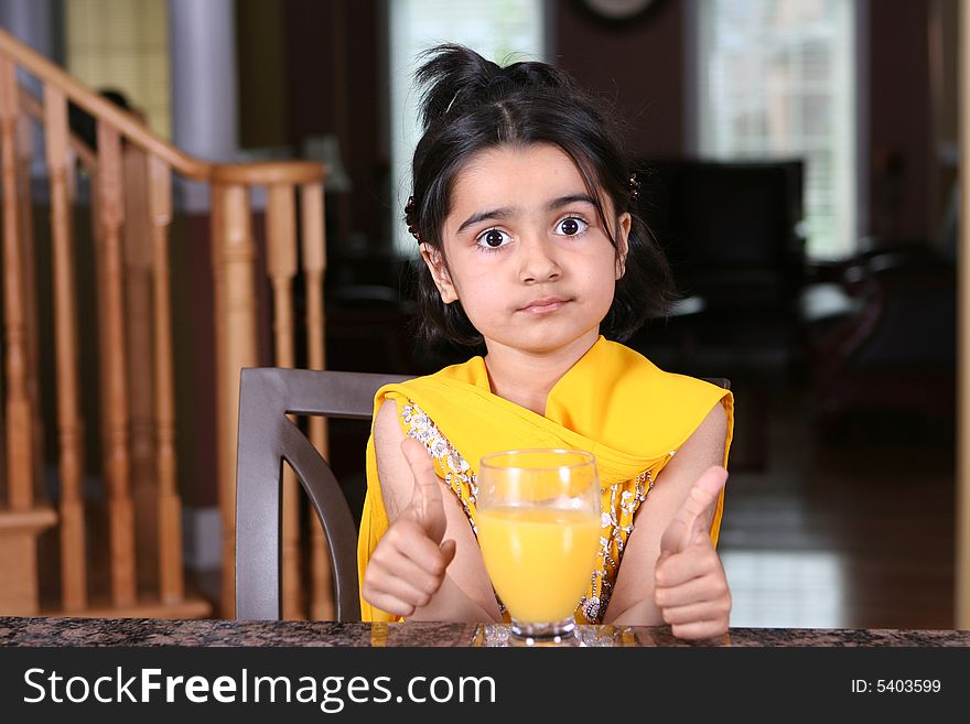 Little girl posing with orange juice